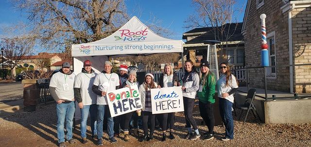Volunteers in Front of Root for Kids Canopy at Green Gate Village